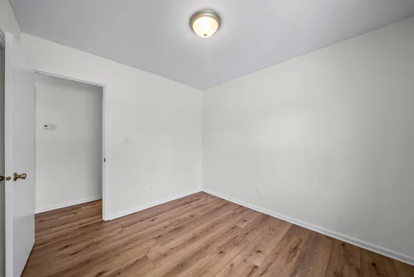 a view of a room with wooden floor and a sink