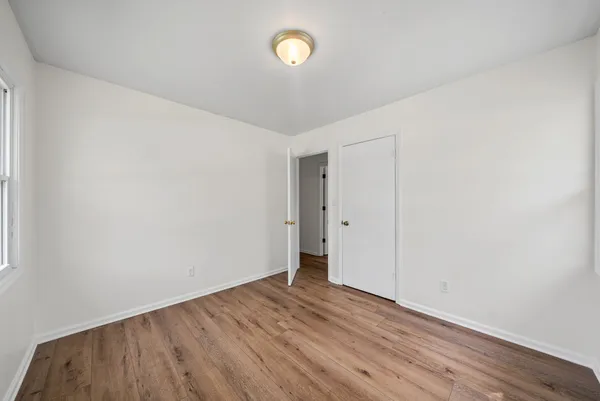 a view of room with wooden floor