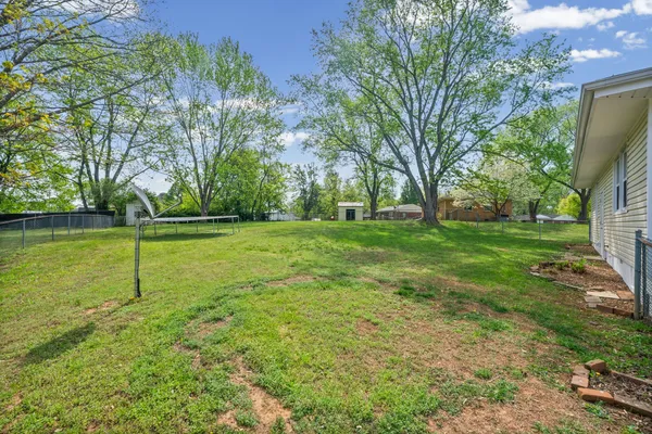 a view of a grassy field with trees