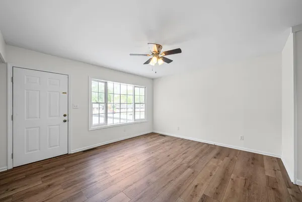 wooden floor in an empty room with a window