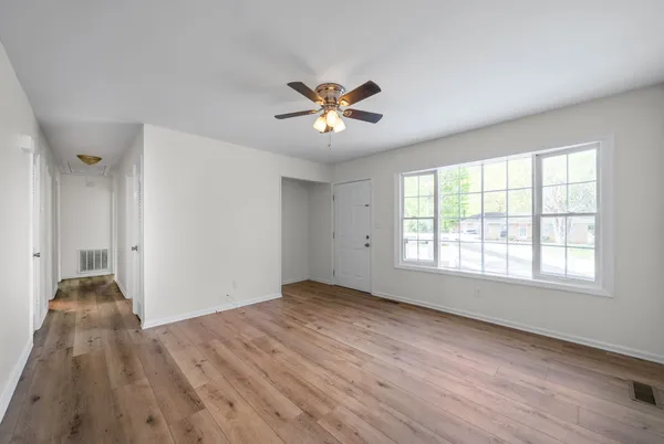 a view of a livingroom with a ceiling fan and window