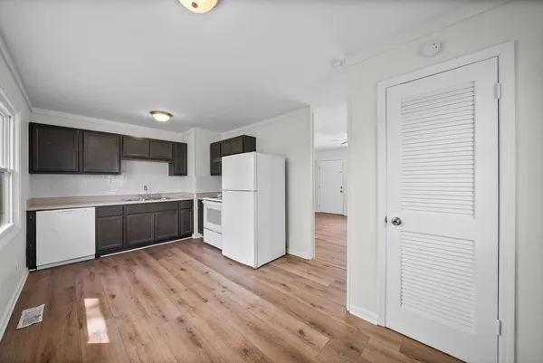 a kitchen with a refrigerator a sink and cabinets