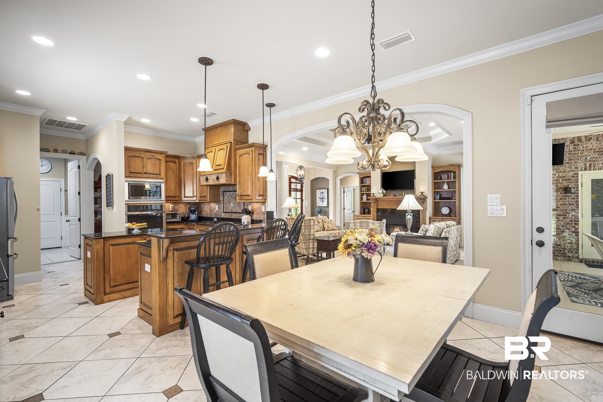 7090 Carson Lane Daphne, AL 36527 - Photo 13 of 37 Tiled dining area featuring crown molding and a chandelier