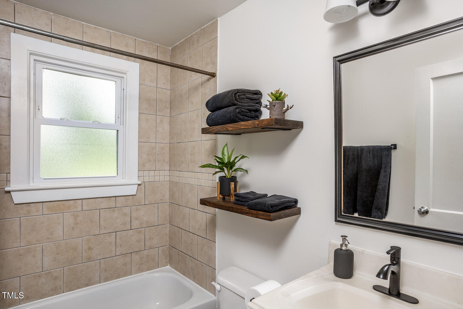 2331 Stevens Road Raleigh, NC 27610 - Photo 22 of 33 a bathroom with a sink and a mirror