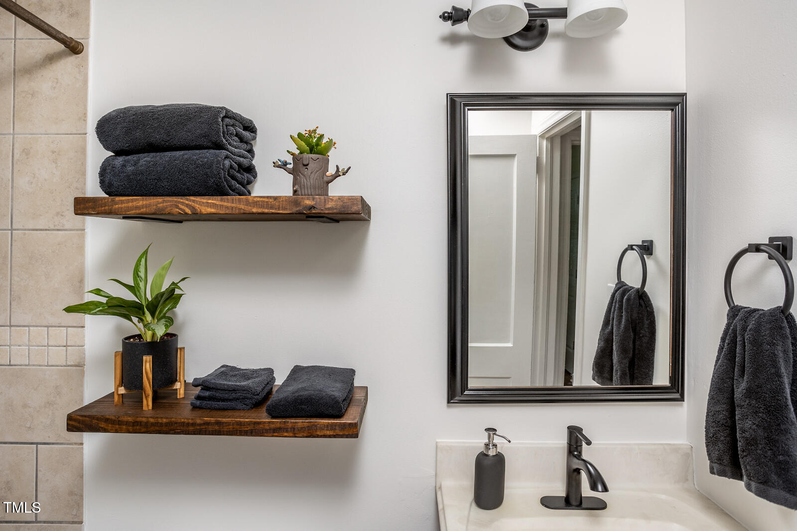 2331 Stevens Road Raleigh, NC 27610 - Photo 23 of 33 a bathroom with a sink and a mirror