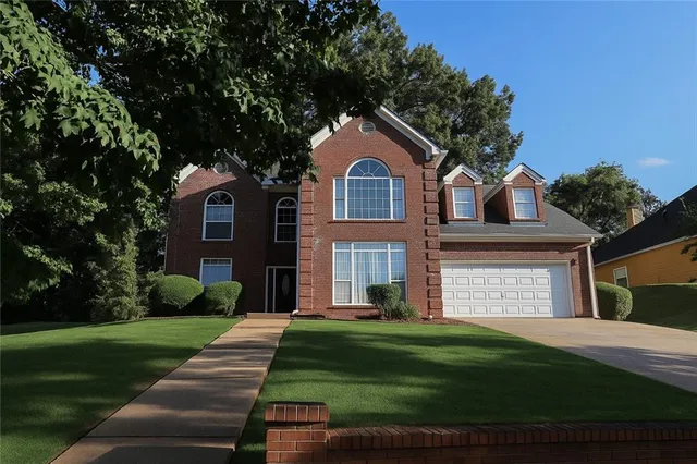 a front view of a house with a yard