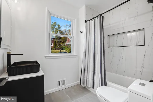 a kitchen with stainless steel appliances granite countertop a refrigerator stove top oven and cabinets with wooden floor