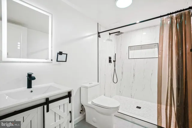 a view of a room with wooden floor and a window