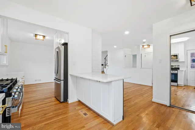 a kitchen with a sink stove top oven and cabinets