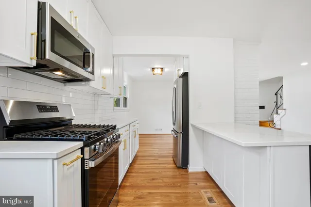 a view of kitchen with cabinets and wooden floor