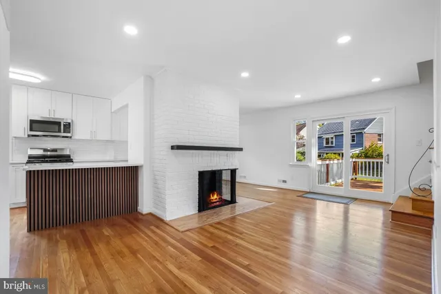 a kitchen with wooden floors and white cabinets