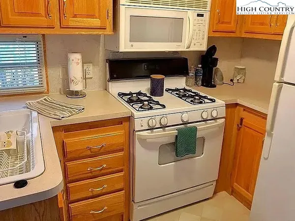 a stove top oven sitting inside of a kitchen