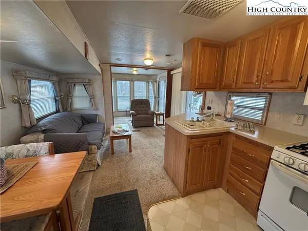 a kitchen with a refrigerator and a stove top oven