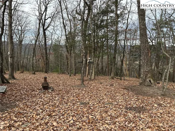 a sign board with buildings in the background