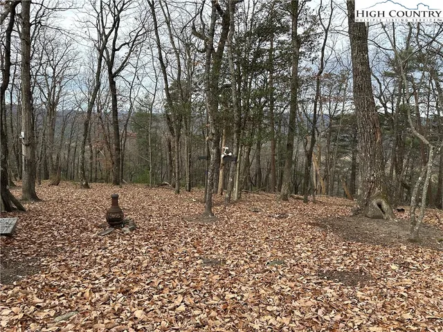 a sign board with buildings in the background