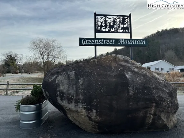 a patio with a table and chairs under an umbrella