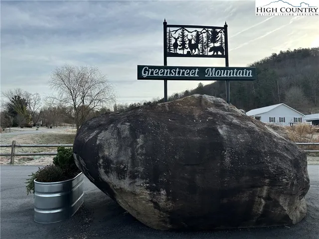 a patio with a table and chairs under an umbrella