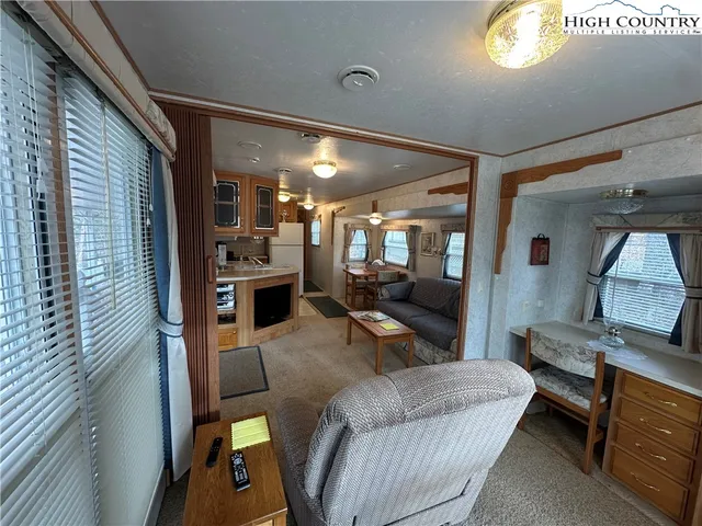 a living room with furniture and a chandelier