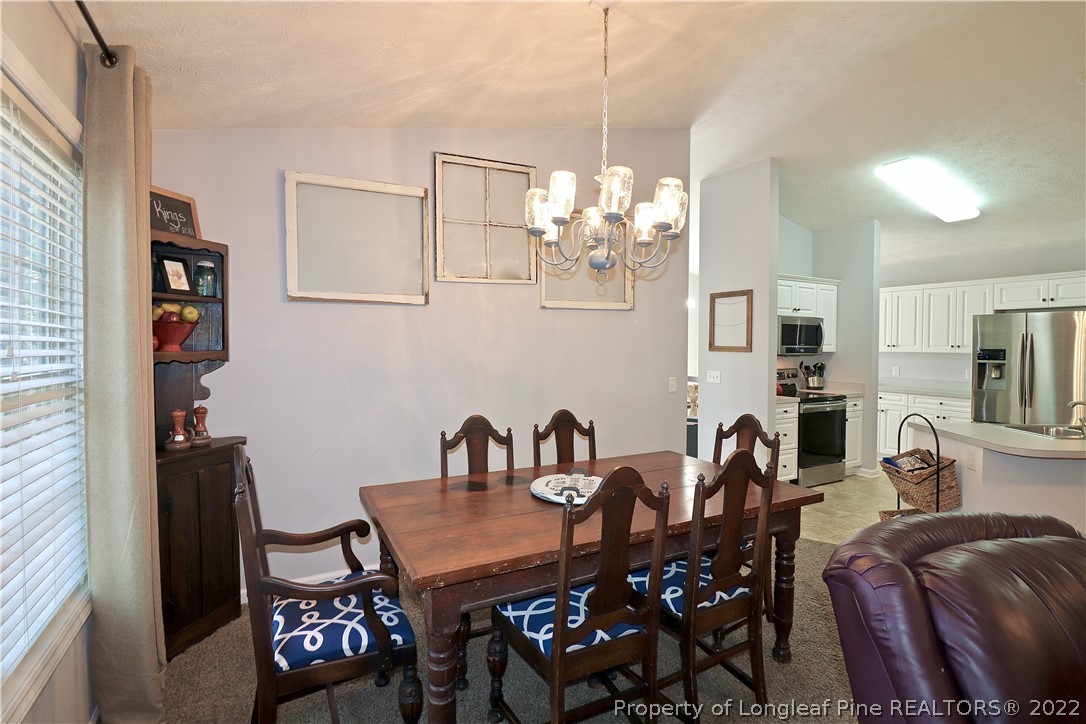 25 Fox Run Road Pinehurst, NC 28374 - Photo 13 of 28 a view of a dining room with furniture and a chandelier
