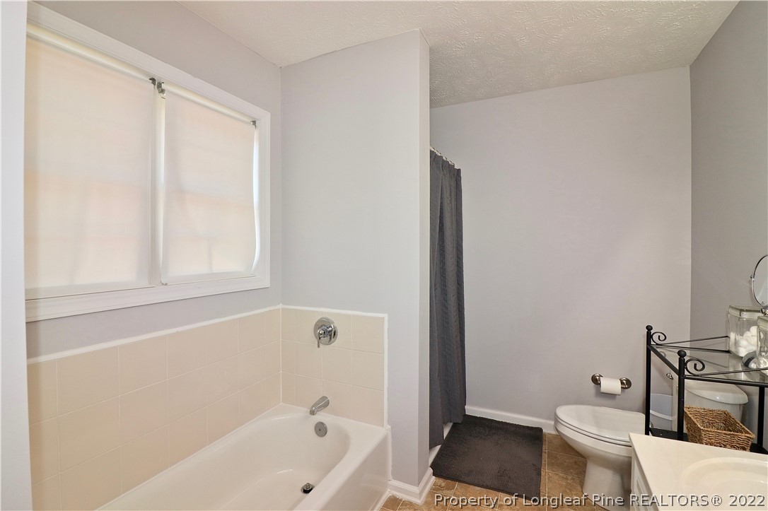 25 Fox Run Road Pinehurst, NC 28374 - Photo 16 of 28 a bathroom with a toilet and a bathtub