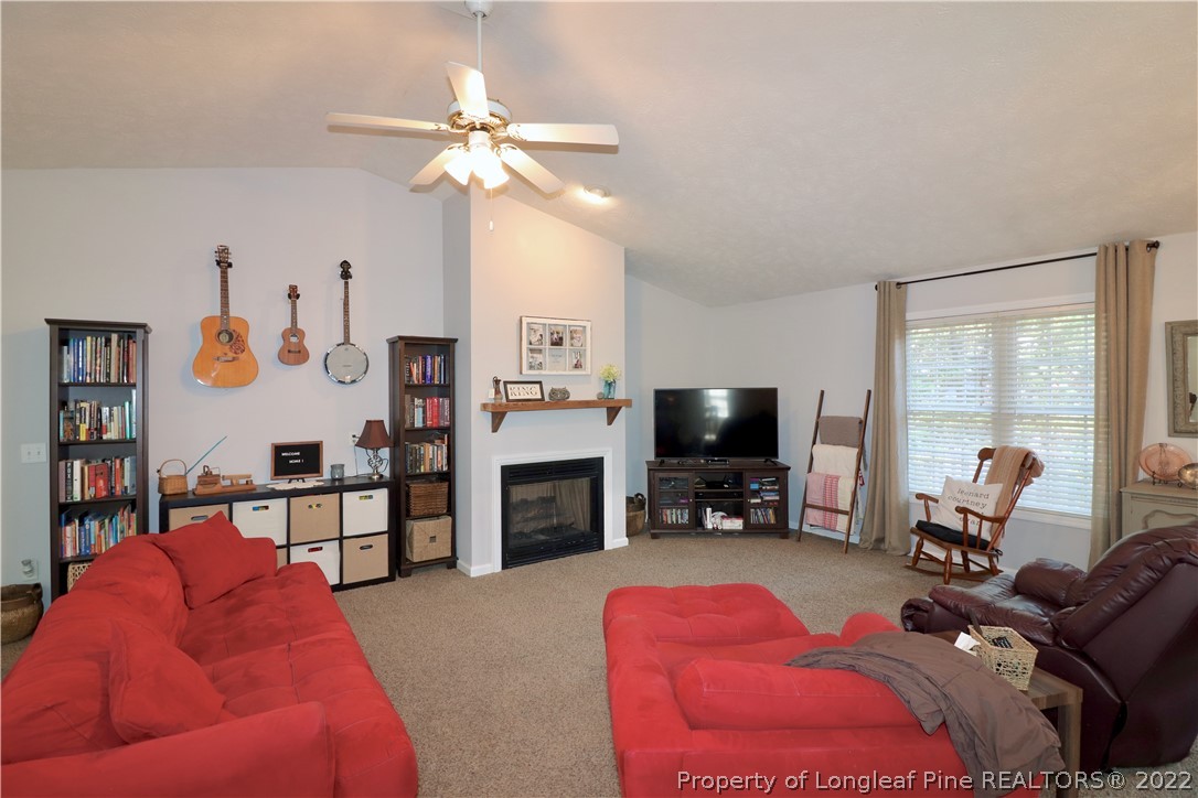 25 Fox Run Road Pinehurst, NC 28374 - Photo 5 of 28 a living room with furniture and a flat screen tv