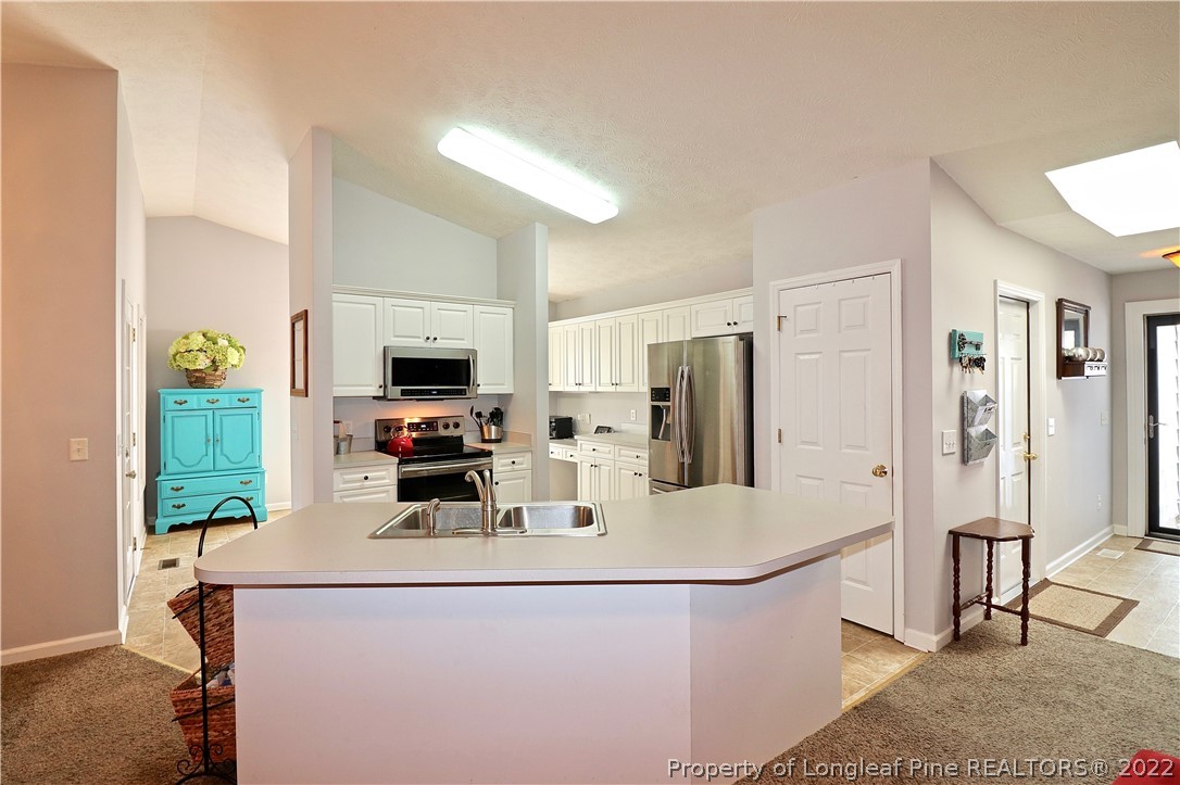 25 Fox Run Road Pinehurst, NC 28374 - Photo 6 of 28 a kitchen with stainless steel appliances a refrigerator and a stove top oven