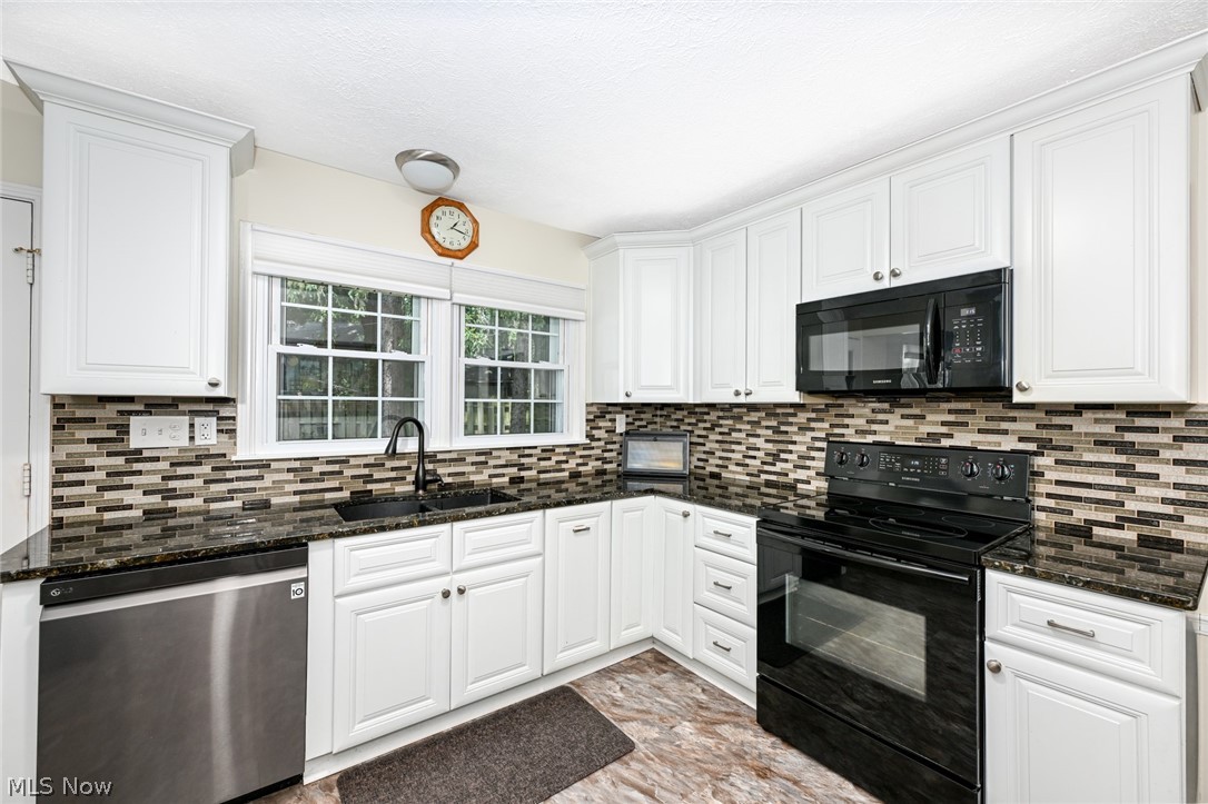 24481 Barrett Road Olmsted Falls, OH 44138 - Photo 24 of 49 Kitchen featuring white cabinetry, black appliances, tile floors, backsplash, and sink