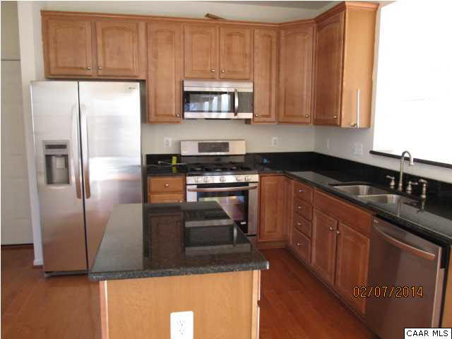 655 Reedy Creek Road Louisa, VA 23093 - Photo 3 of 10 a kitchen with stainless steel appliances granite countertop a refrigerator a stove a sink and a microwave