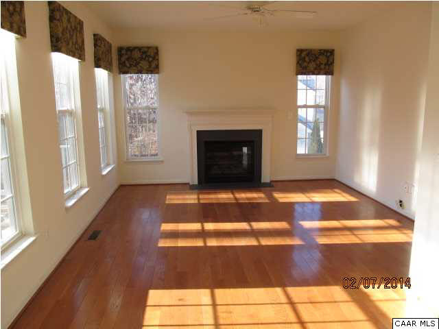 655 Reedy Creek Road Louisa, VA 23093 - Photo 8 of 10 a view of a livingroom with wooden floor and a fireplace