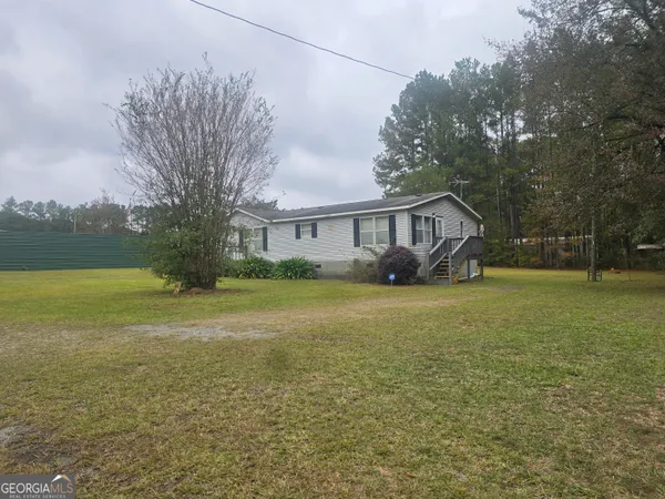 a house view with swimming pool and garden
