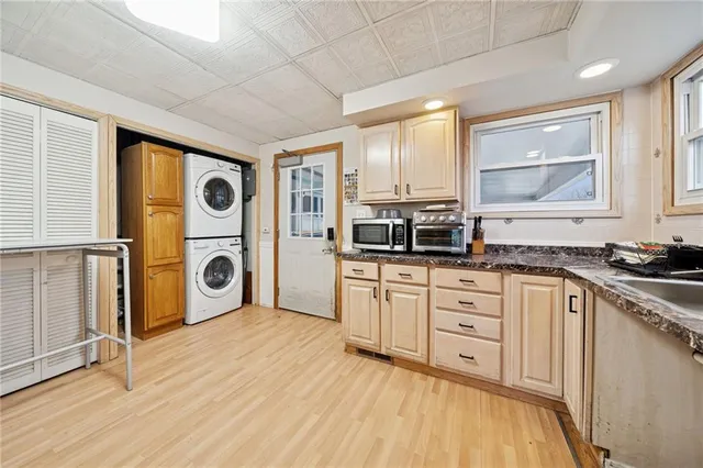 a kitchen with stainless steel appliances a stove a sink and a microwave
