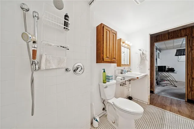 a bathroom with a granite countertop toilet sink and shower