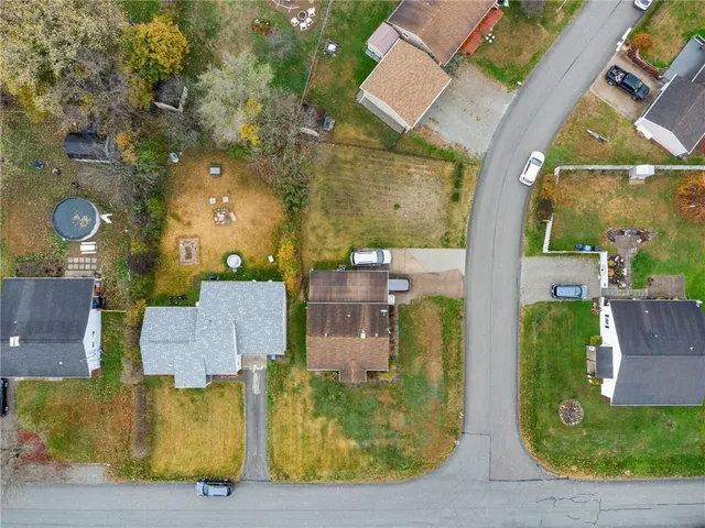 an aerial view of a residential apartment building with a yard