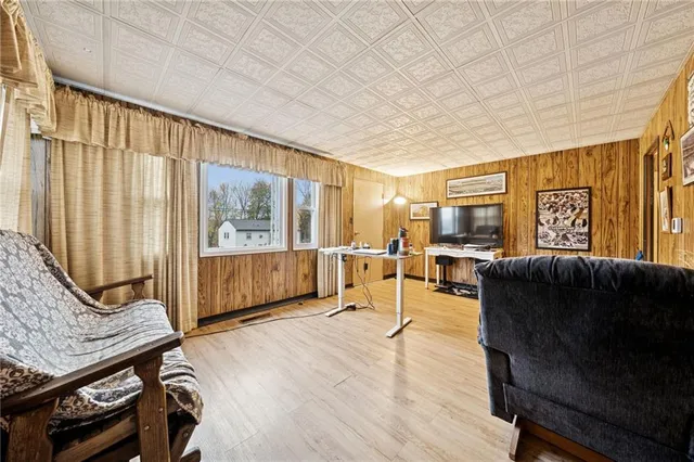 a living room with furniture a window and wooden floor