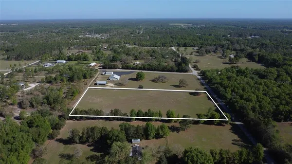an aerial view of house with yard swimming pool and outdoor seating