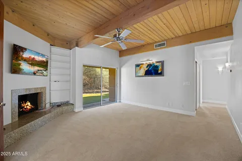 a view of a livingroom with an empty space and a fireplace