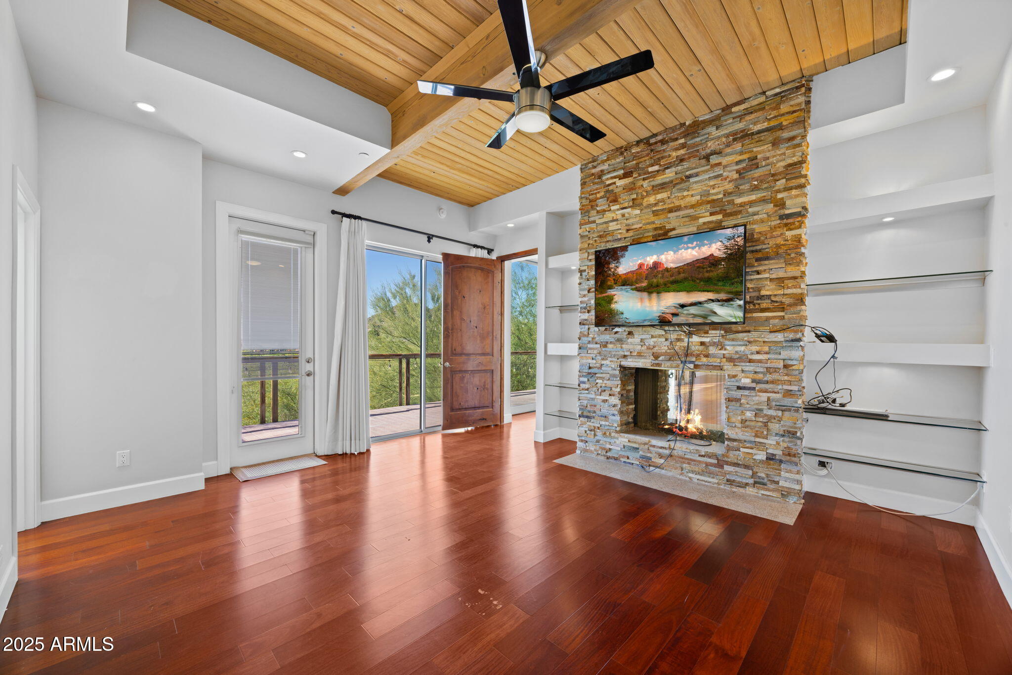 4820 East Cottontail Run Road Paradise Valley, AZ 85253 - Photo 15 of 22 a view of a livingroom with fireplace wooden floor and windows