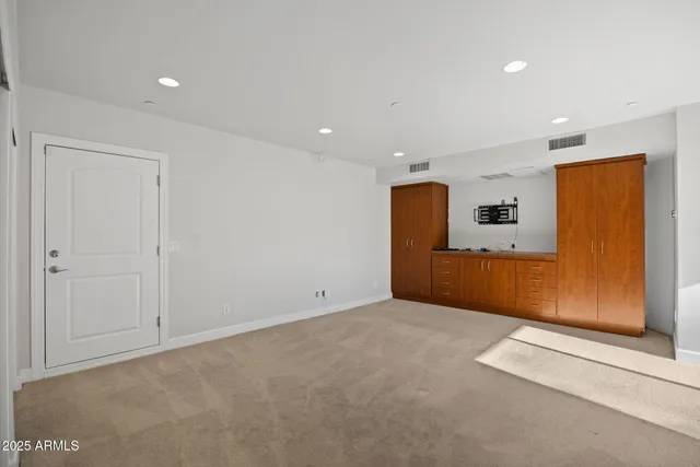 a view of empty room with wooden floor and floor to ceiling window