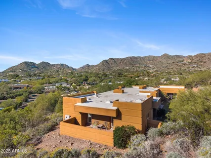 an aerial view of residential houses with outdoor space and trees