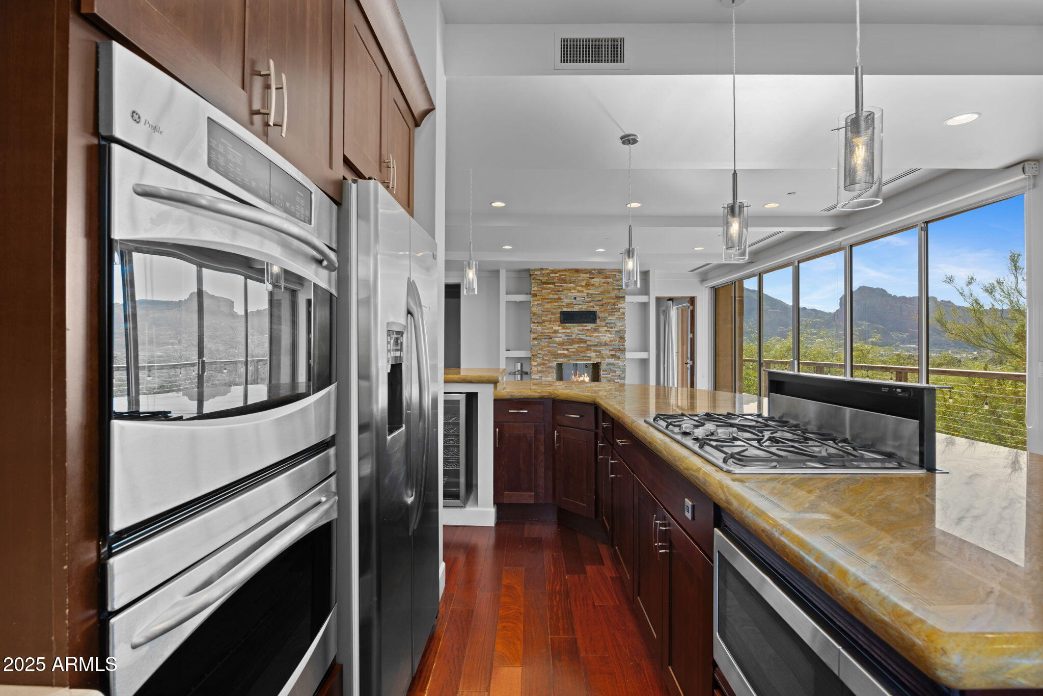 4820 East Cottontail Run Road Paradise Valley, AZ 85253 - Photo 6 of 22 a kitchen with stainless steel appliances granite countertop a lot of counter space and wooden floors
