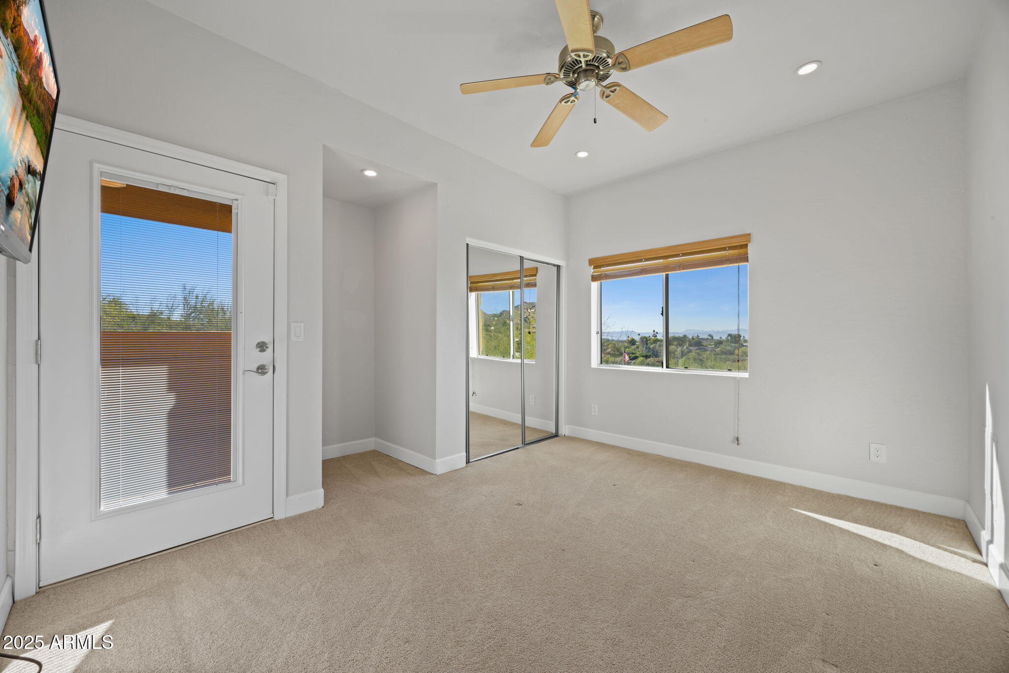 4820 East Cottontail Run Road Paradise Valley, AZ 85253 - Photo 9 of 22 an empty room with windows and fan
