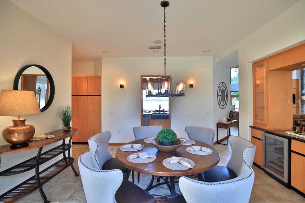 11035 Southeast Sunset Harbor Road Summerfield, FL 34491 - Photo 17 of 97 a dining room with furniture and wooden floor
