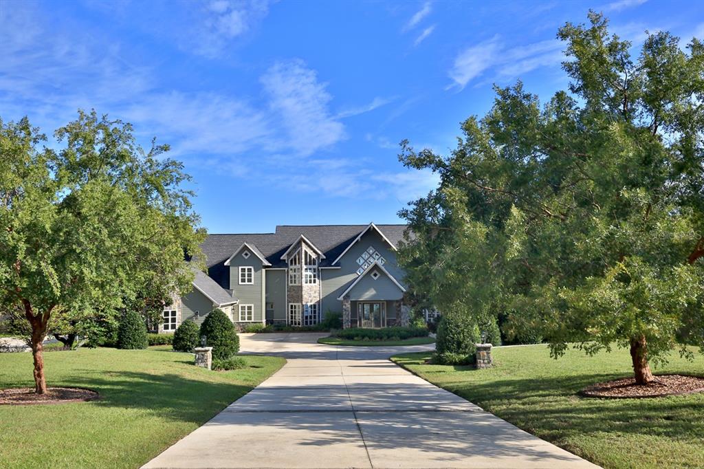 11035 Southeast Sunset Harbor Road Summerfield, FL 34491 - Photo 4 of 97 a front view of a house with a yard