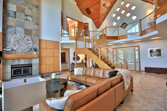 a living room with furniture a fireplace and a flat screen tv