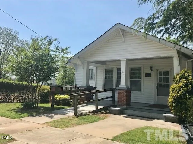 a view of a house with a yard and sitting area