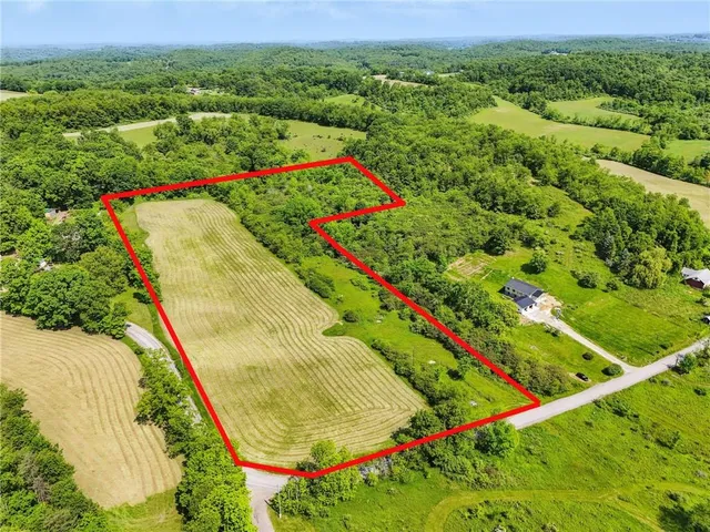 an aerial view of residential house and car parked