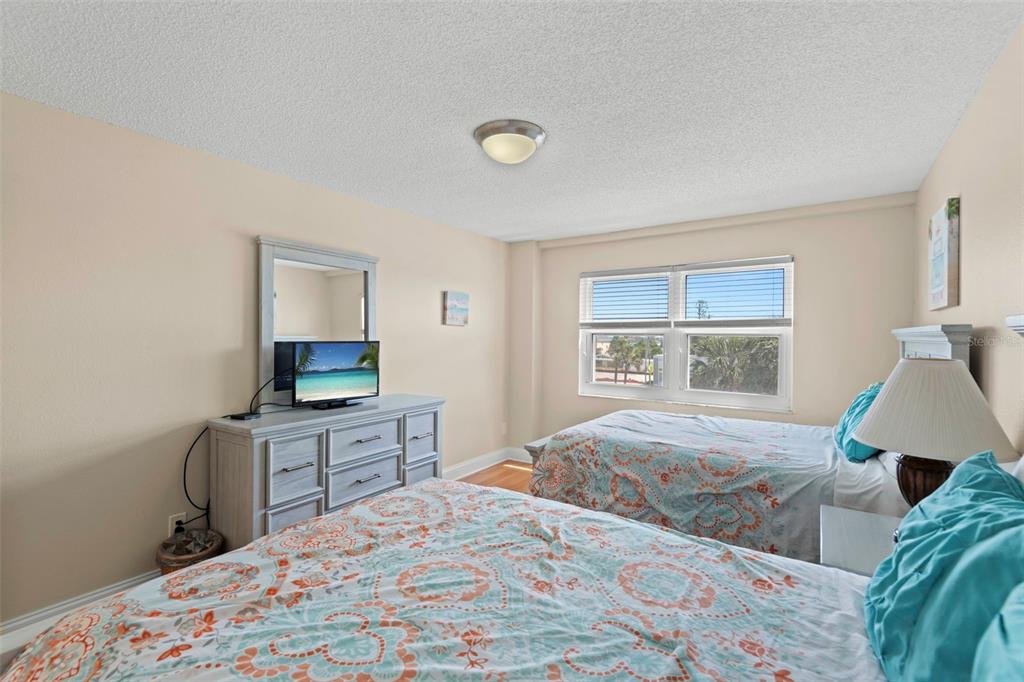 13440 Gulf Lane, Unit 202 Madeira Beach, FL 33708 - Photo 12 of 41 a bedroom with a bed and a window