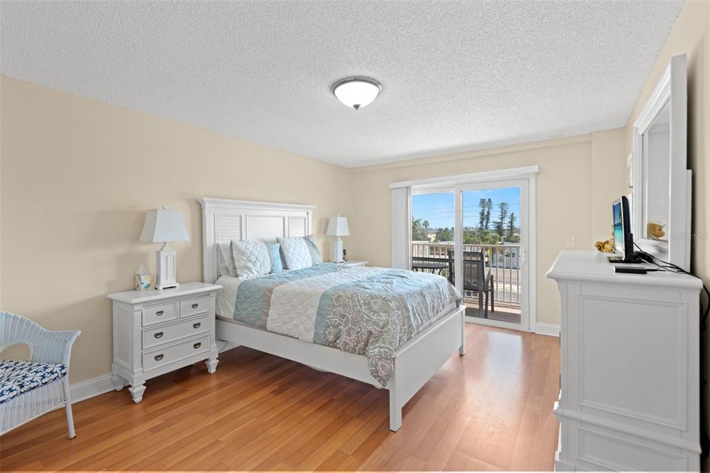 13440 Gulf Lane, Unit 202 Madeira Beach, FL 33708 - Photo 17 of 41 a bedroom with a bed and a dresser