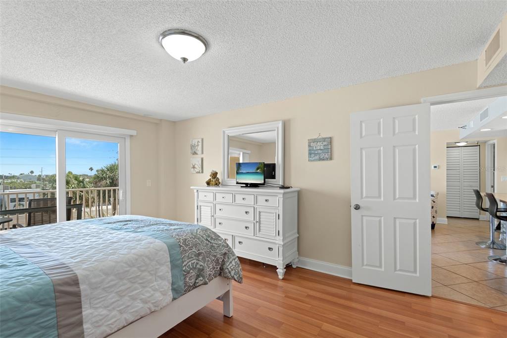 13440 Gulf Lane, Unit 202 Madeira Beach, FL 33708 - Photo 18 of 41 a bedroom with a bed and a large window