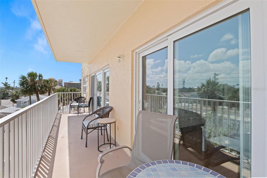 13440 Gulf Lane, Unit 202 Madeira Beach, FL 33708 - Photo 25 of 41 a view of a balcony and chairs